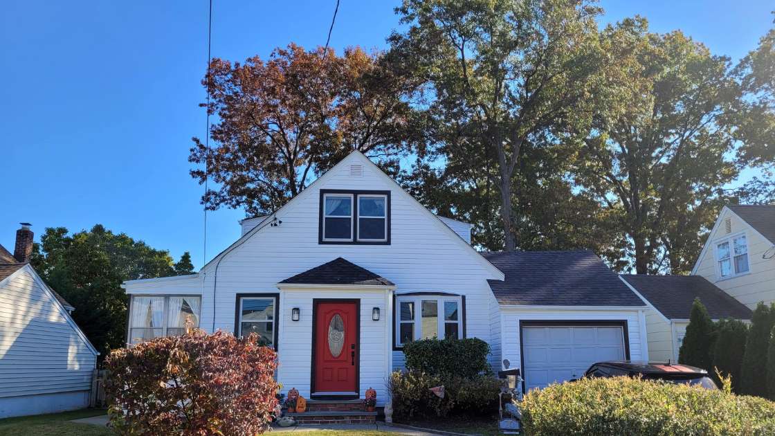 Farmhouse with new white siding